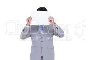 Businessman holding blank sign in front of his head