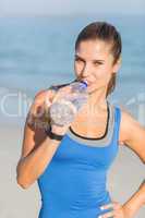 Portrait of beautiful fit woman drinking water