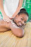 Pretty woman enjoying a salt scrub massage