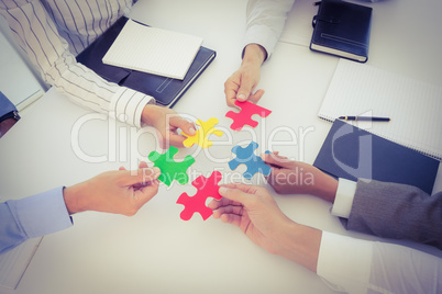 Business colleagues holding piece of puzzle