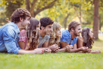 Friends lying and talking in the park