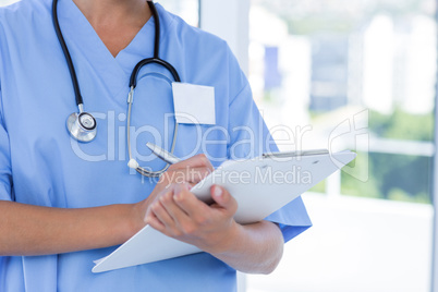 Doctor writing on clipboard Doctor writing on clipboard
