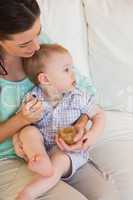 Happy mother eating with her baby boy