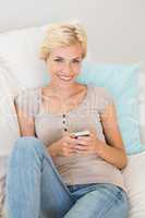 Portrait smiling blonde woman using mobile