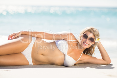 Pretty blonde woman lying beside the sea