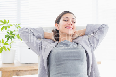 Businesswoman relaxing in a swivel chair