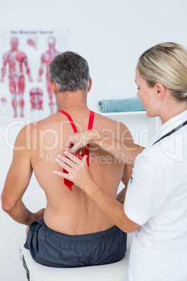 Doctor examining her patient back