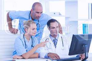 Teams of doctors working on laptop computer