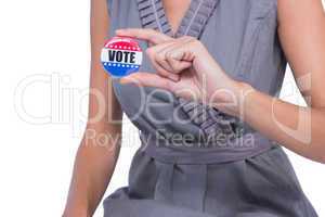 A Woman showing vote badge