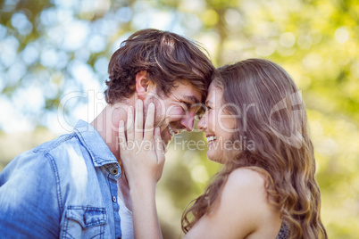 Hipster couple smiling at each other