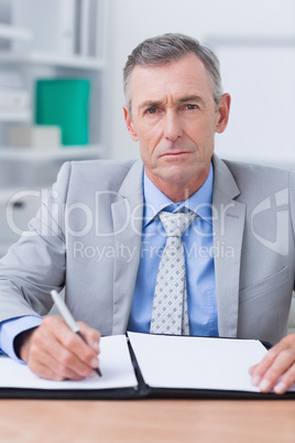 Unhappy businessman looking at camera