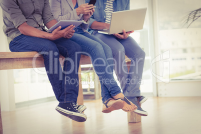 Three creative business team working on electronic devices