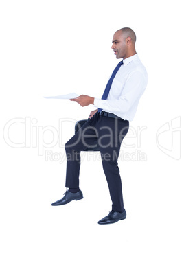 Businessman holding paper and suitcase