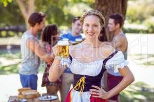 Pretty oktoberfest blonde toasting in the park