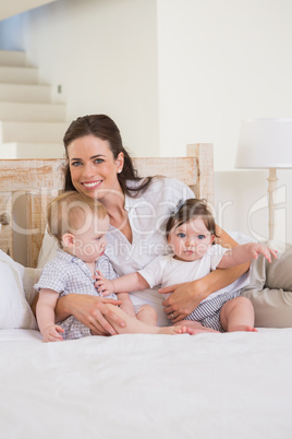 Happy mother with cute babies boy and girl