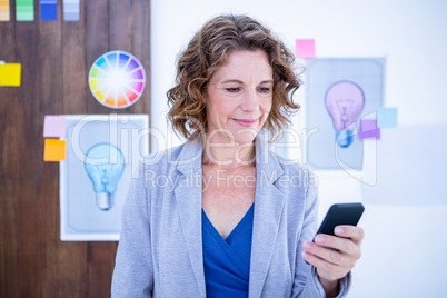 Creative businesswoman using her smartphone