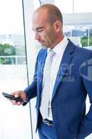 Businessman texting with his smartphone