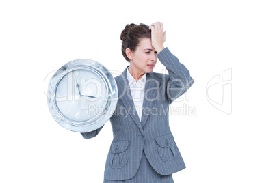 Businesswoman in suit holding a clock