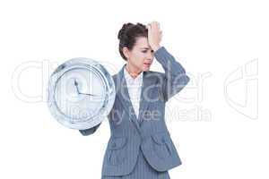 Businesswoman in suit holding a clock