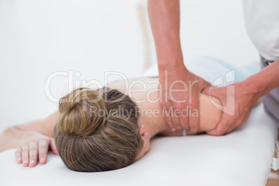 Physiotherapist doing arm massage to his patient