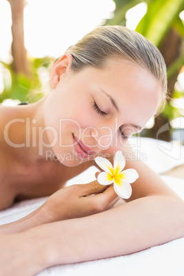 Peaceful blonde lying on towel