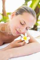 Peaceful blonde lying on towel