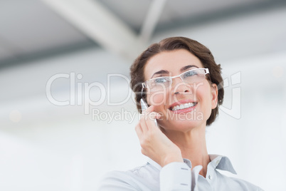 Smiling businesswoman on the phone wearing eye glasses