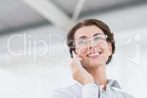 Smiling businesswoman on the phone wearing eye glasses