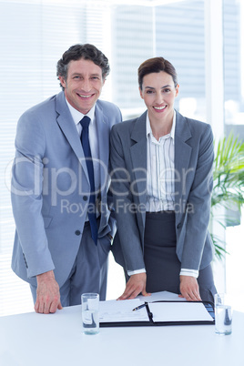 Smiling business people looking at camera