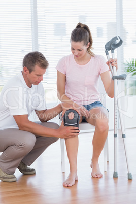 Doctor examining his patient knee Doctor examining his patient knee