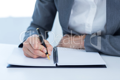 Businesswoman writing in her diary