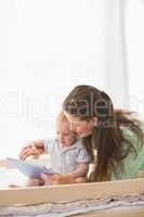 Happy mother using tablet with his baby boy