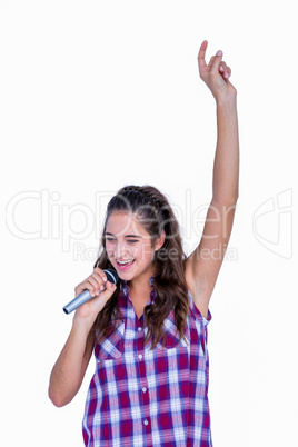 Happy pretty brunette singing on microphone
