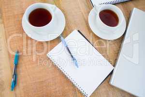 Overhead of coffee and notebook on the desk