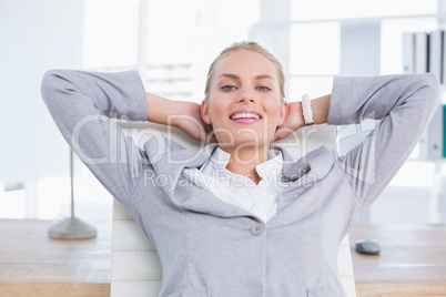 Smiling businesswoman relaxing on her office