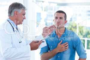 Doctor examining his patients neck