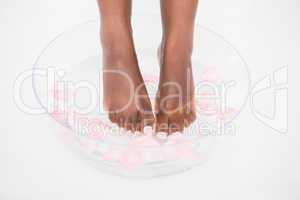 Woman soaking her foot in a bowl