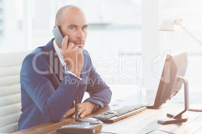 Businessman looking at camera and calling