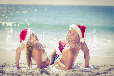 Lying cute couple wearing christmas hats