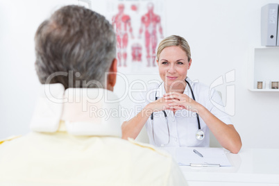 Doctor looking at patient wearing neck brace