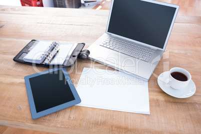 Diary with laptop and tablet on a desk