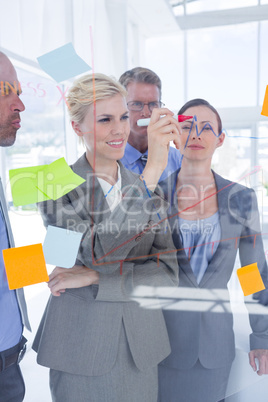 Businesswoman drawing graph on the board