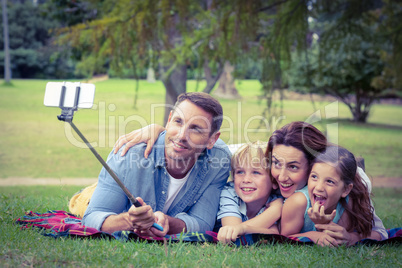 Happy family in the park taking selfie