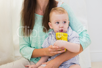 Mother giving baby a drink