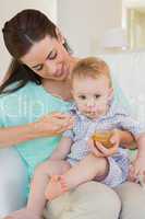 Happy mother eating with her baby boy