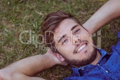 Young man lying down in the park