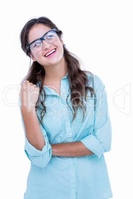 Pretty geeky hipster with a hand in her hair looking away