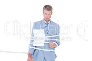 Serious businessman tied up at work