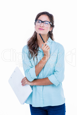 Thoughtful geeky hipster with a pen against her chin