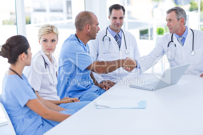 Doctors doing hands shakes